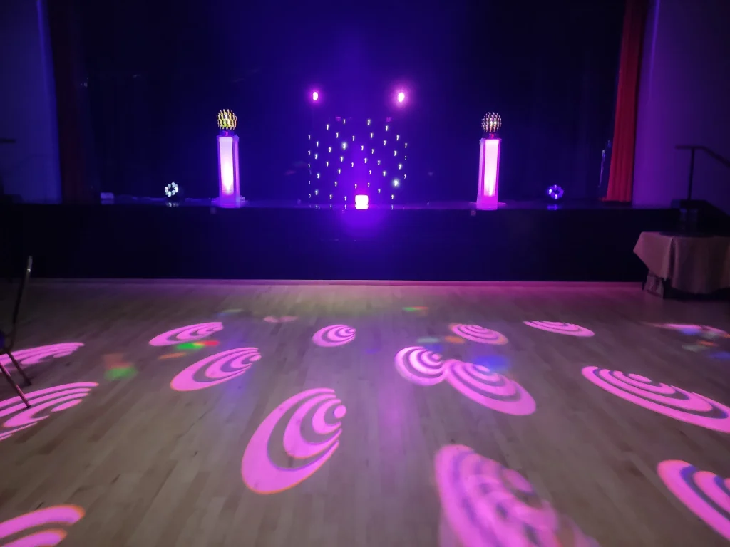 Disco Hire Near Me - Empty dance floor showing the disco with pink logos on the dance floor